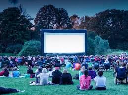 crowd watching large screen outdoors